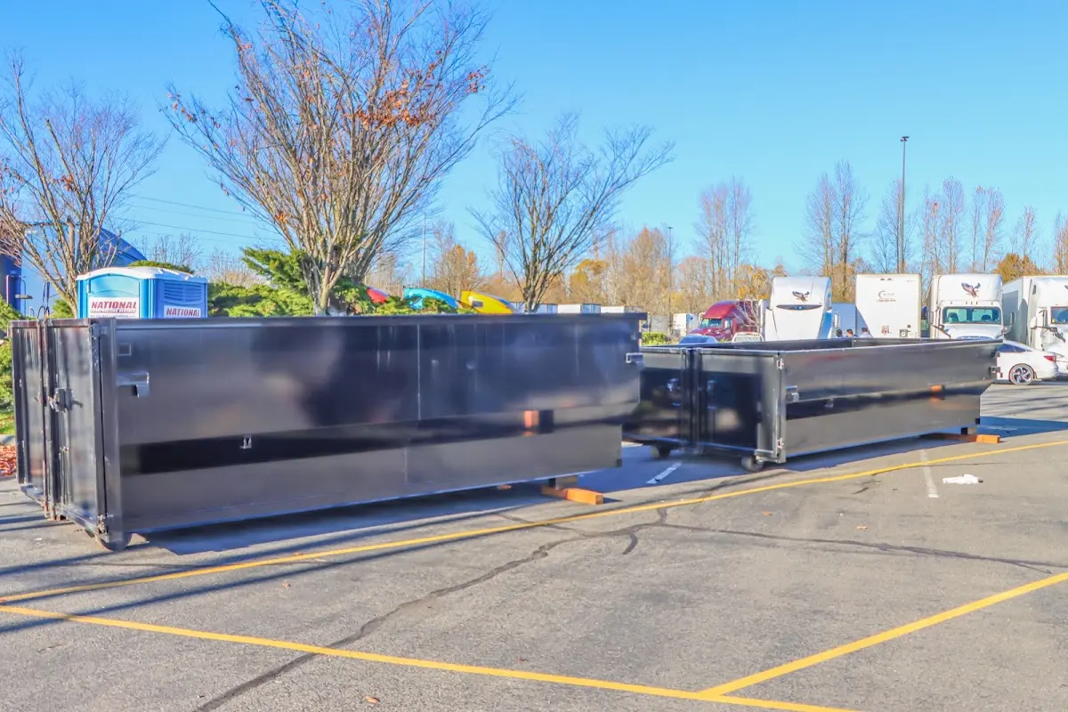 Professional dumpster rental service with roll-off container on residential driveway in Spring Hill